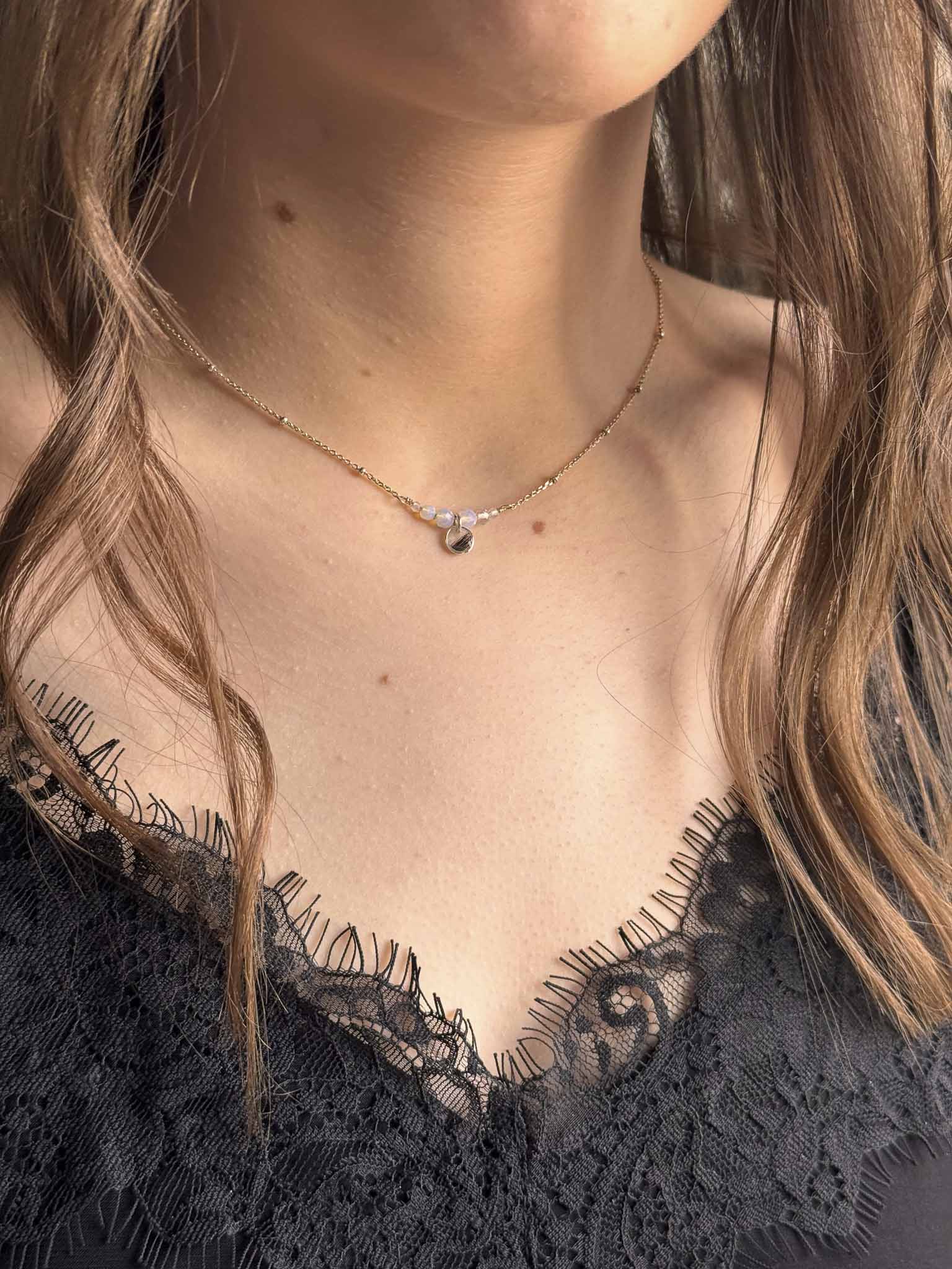 Collier Opale au pendentif goutte, chaîne fine avec petites pierres brillantes.